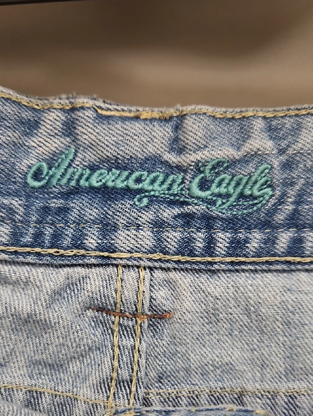 American Eagle | Y2K light denim shorts distressed flap-closure back pockets. 12 - Picture 8 of 13